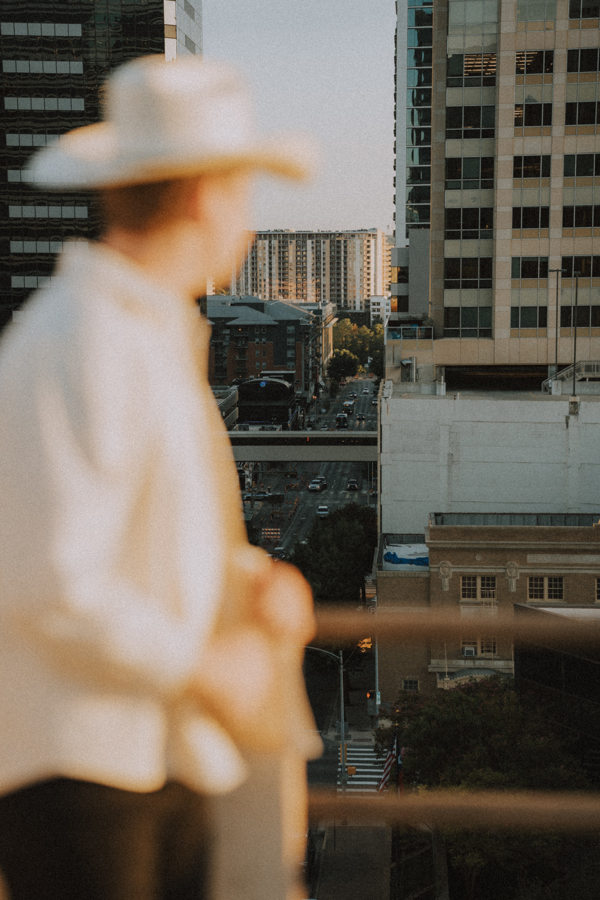 Blurred figure in the foreground looking out at the city skyline in the background